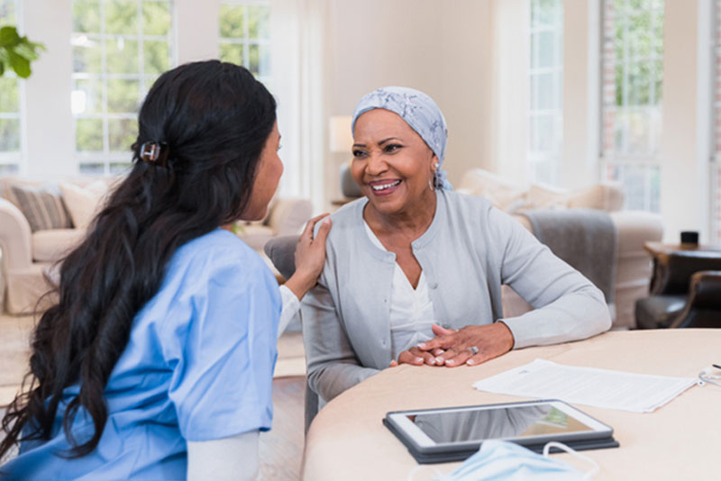 caregiver comforting happy senior lady